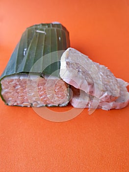 details of sliced raw tempeh on yellow background